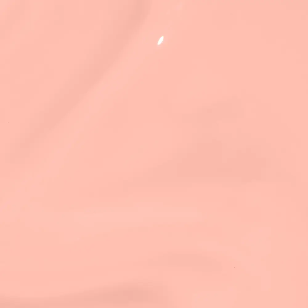 Solid peach-colored background with a small white highlight, abstract image.