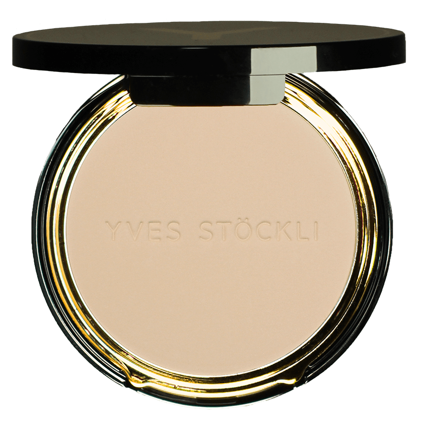 Round beige pressed powder in an Yves Saint Laurent compact with a black lid and gold trim