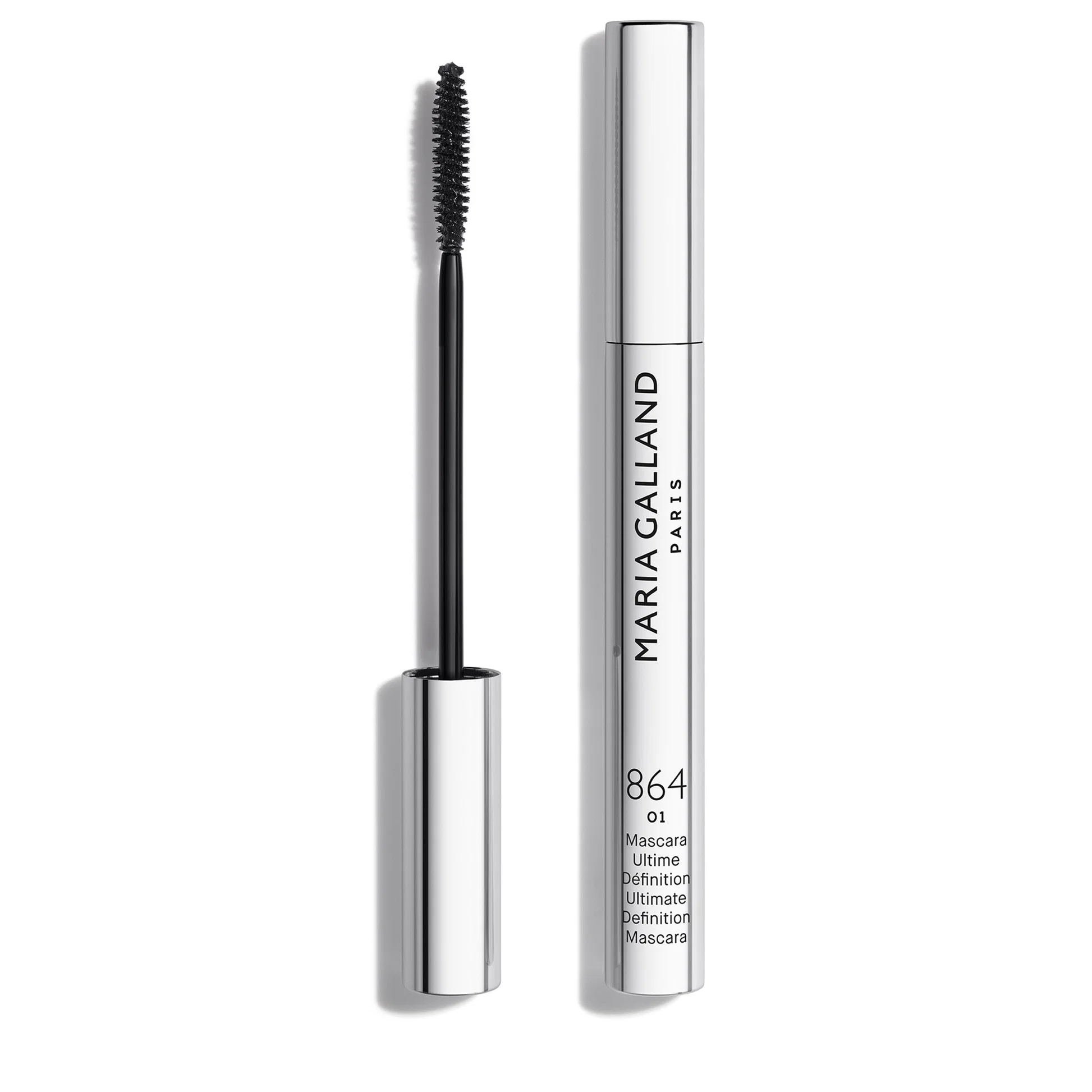 Mascara wand with black bristles beside a silver tube labeled Maria Galland Paris