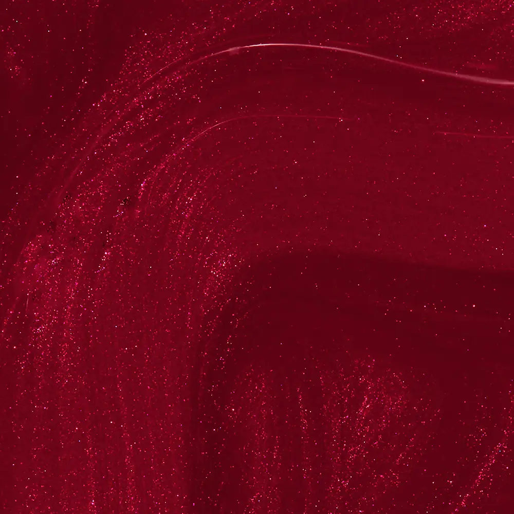 Abstract red background with swirling glitter and sparkles, resembling festive confetti or cosmic dust.
