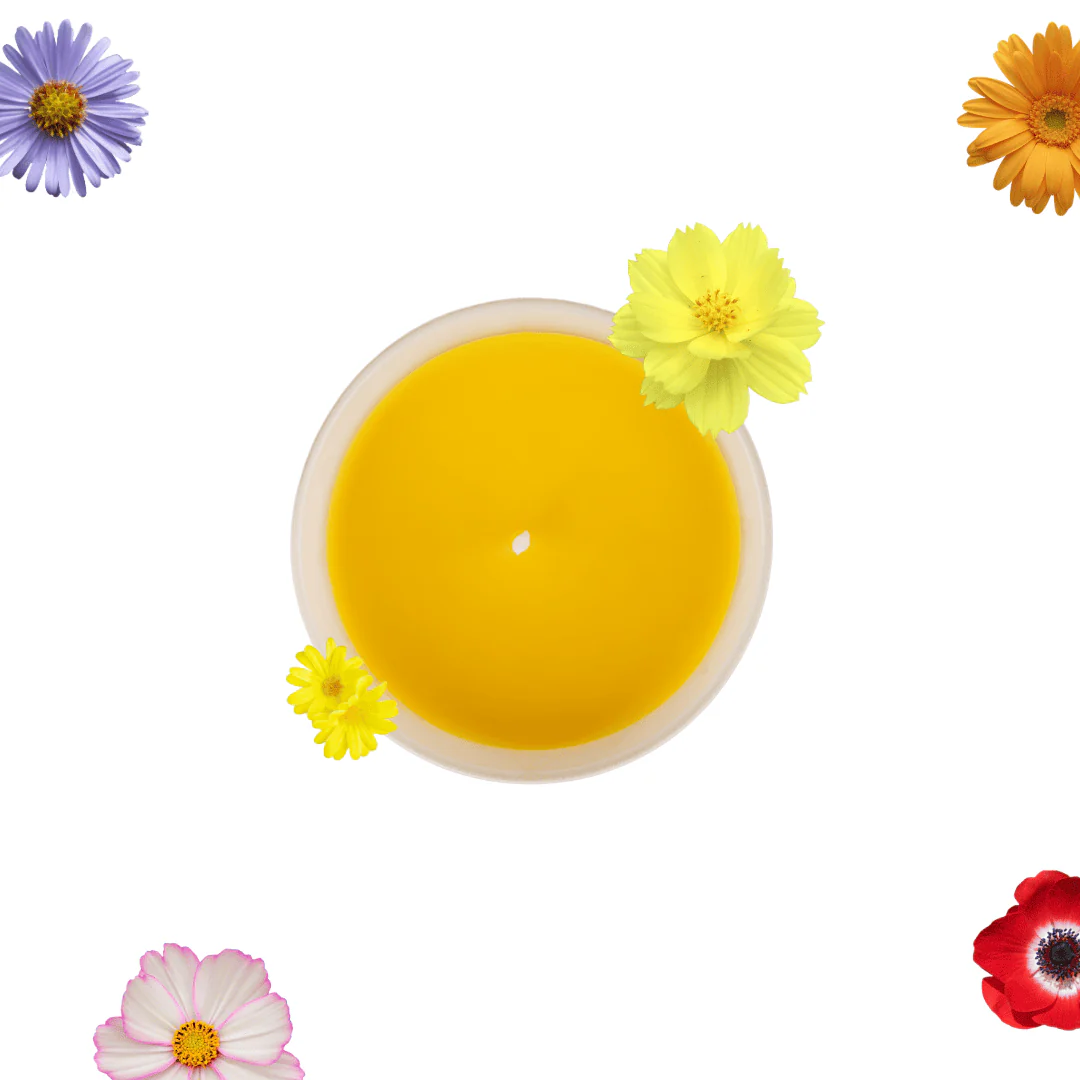 Top-down view of a yellow drink in a white cup, surrounded by colorful flowers on a white background.
