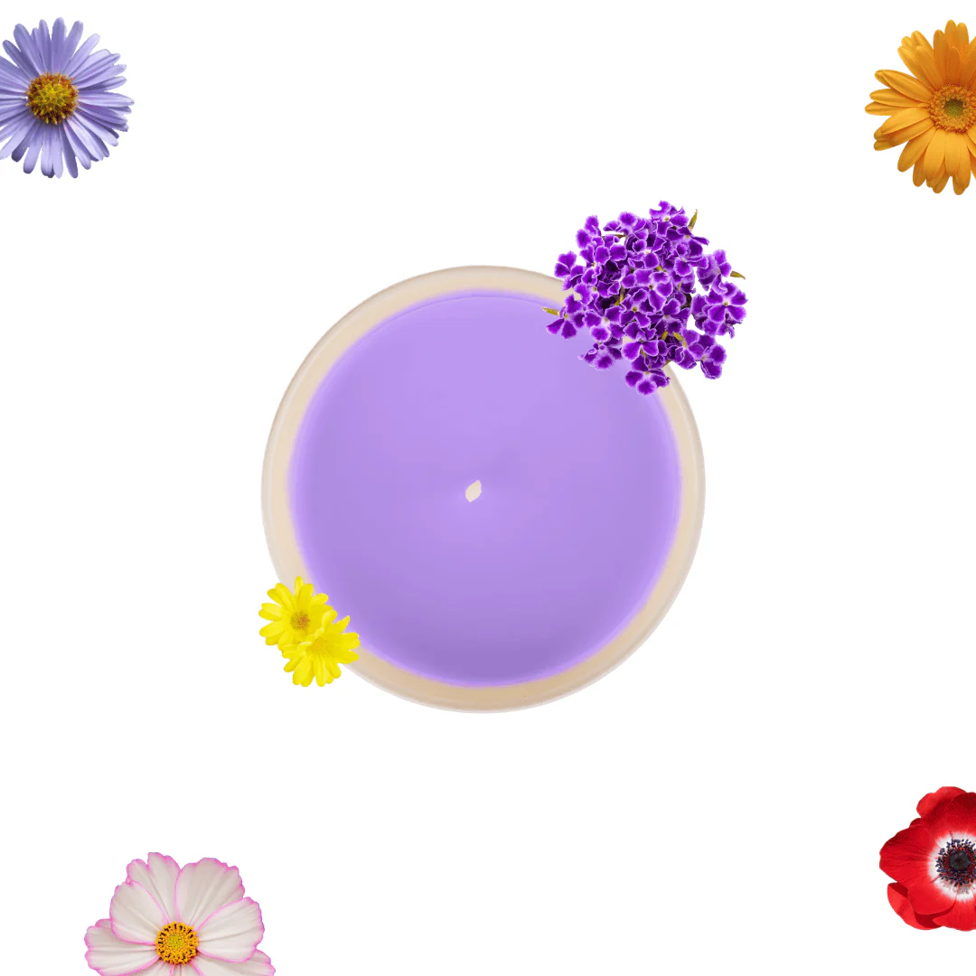 Top-down view of a purple candle in a beige dish, surrounded by colorful flowers at the corners of the image.
