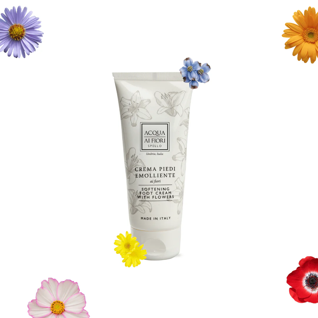 Foot cream tube with floral design and 'Crema Piedi Emolliente' branding, surrounded by colorful flowers on white background.