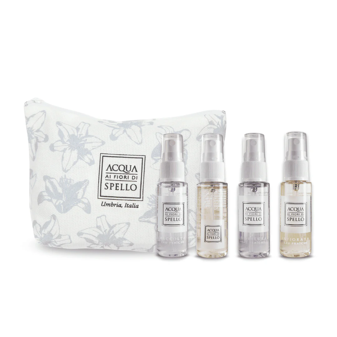 Acqua Ai Fiori Di Spello fragrance gift set: four spray bottles with a white floral pouch behind them.