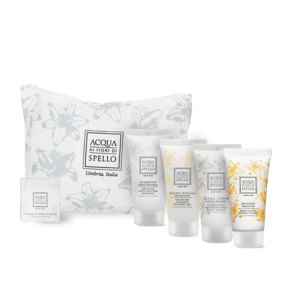 Skincare gift set with a white floral-patterned bag and five tubes/bottles labeled Acqua Ai Fiori di Spello, Umbria, Italia